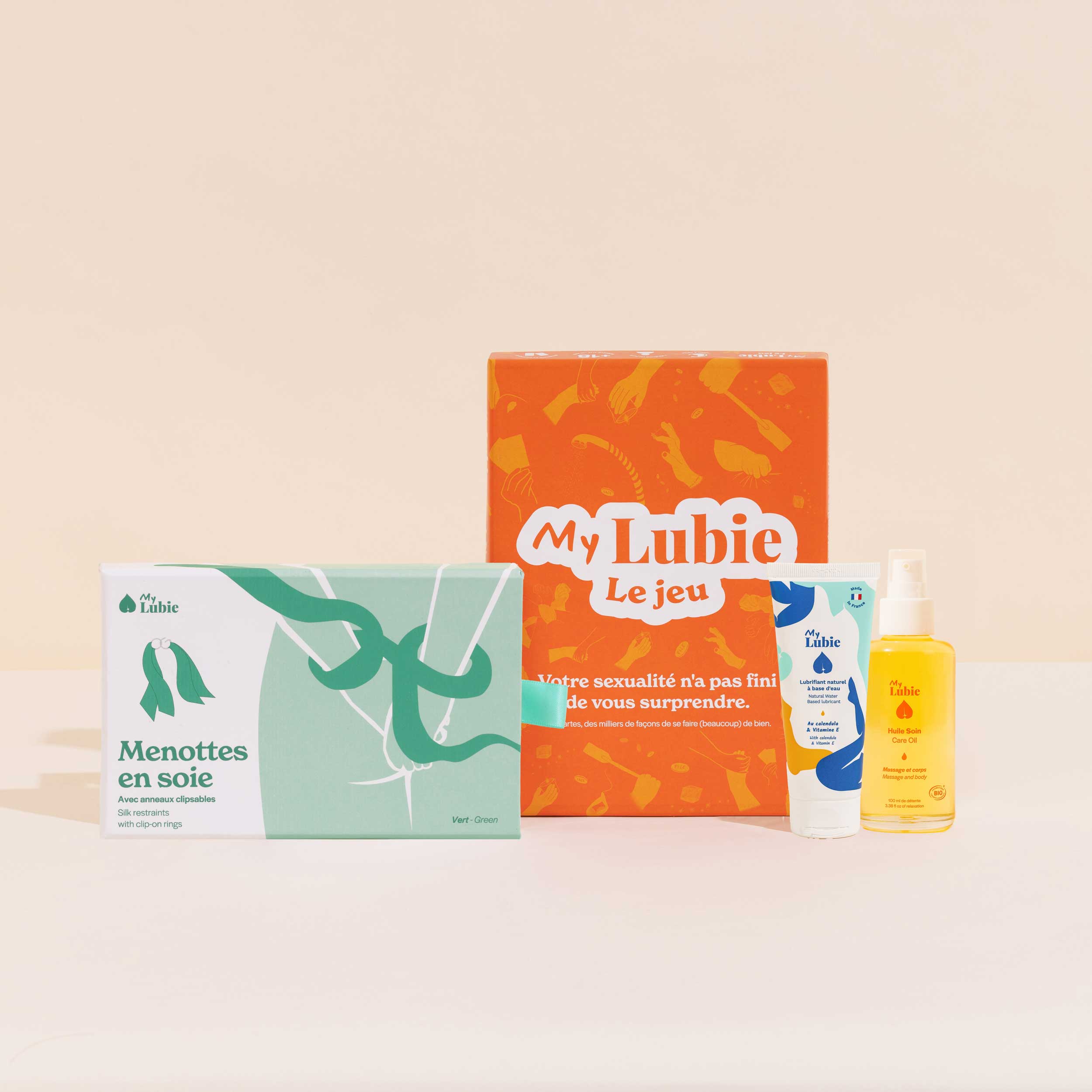 Jeux de nuit, le coffret My Lubie, menottes en soie vert et orange, l'huile soin corps et massage, le lubrifiant naturel fluide