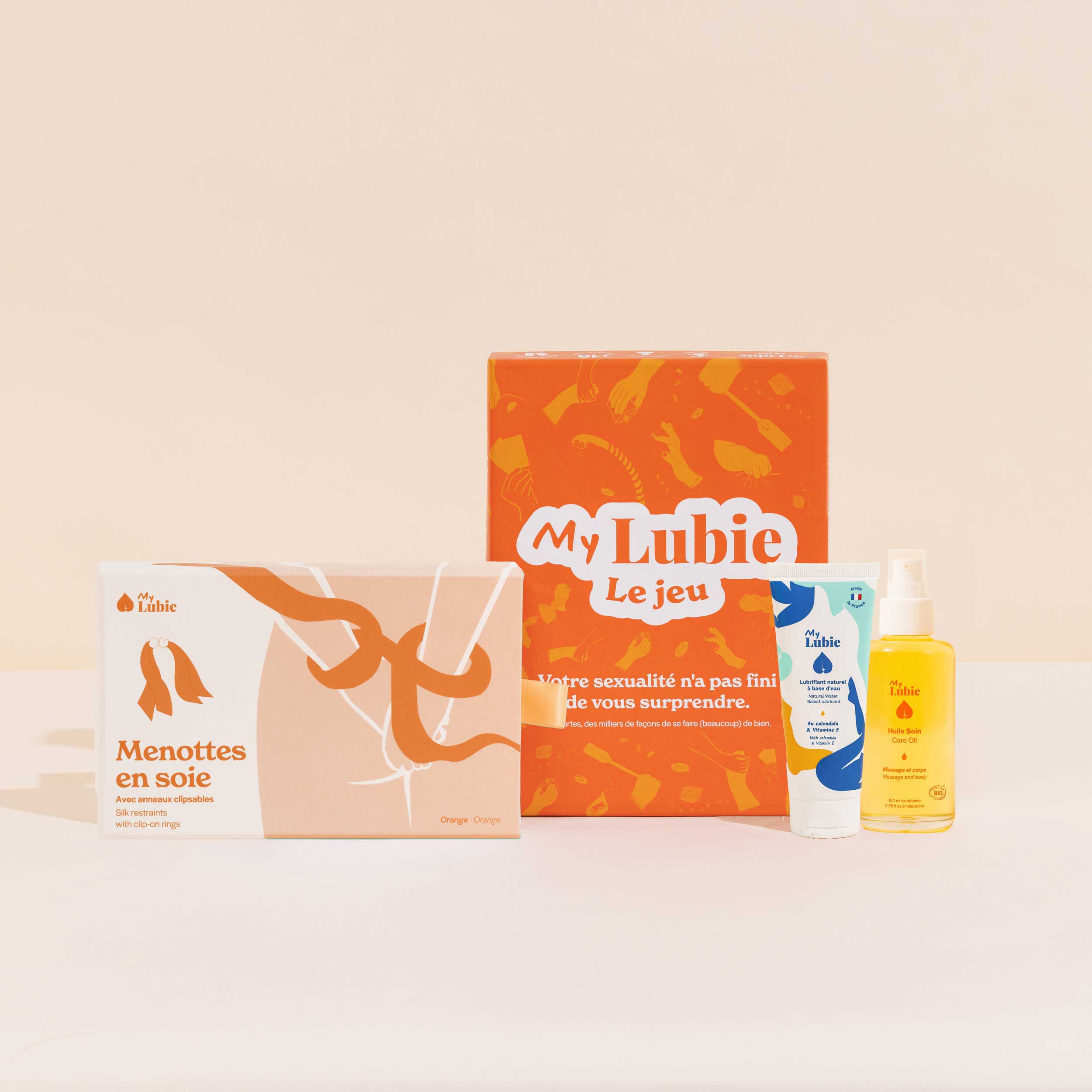 Jeux de nuit, le coffret My Lubie, menottes en soie vert et orange, l'huile soin corps et massage, le lubrifiant naturel fluide
